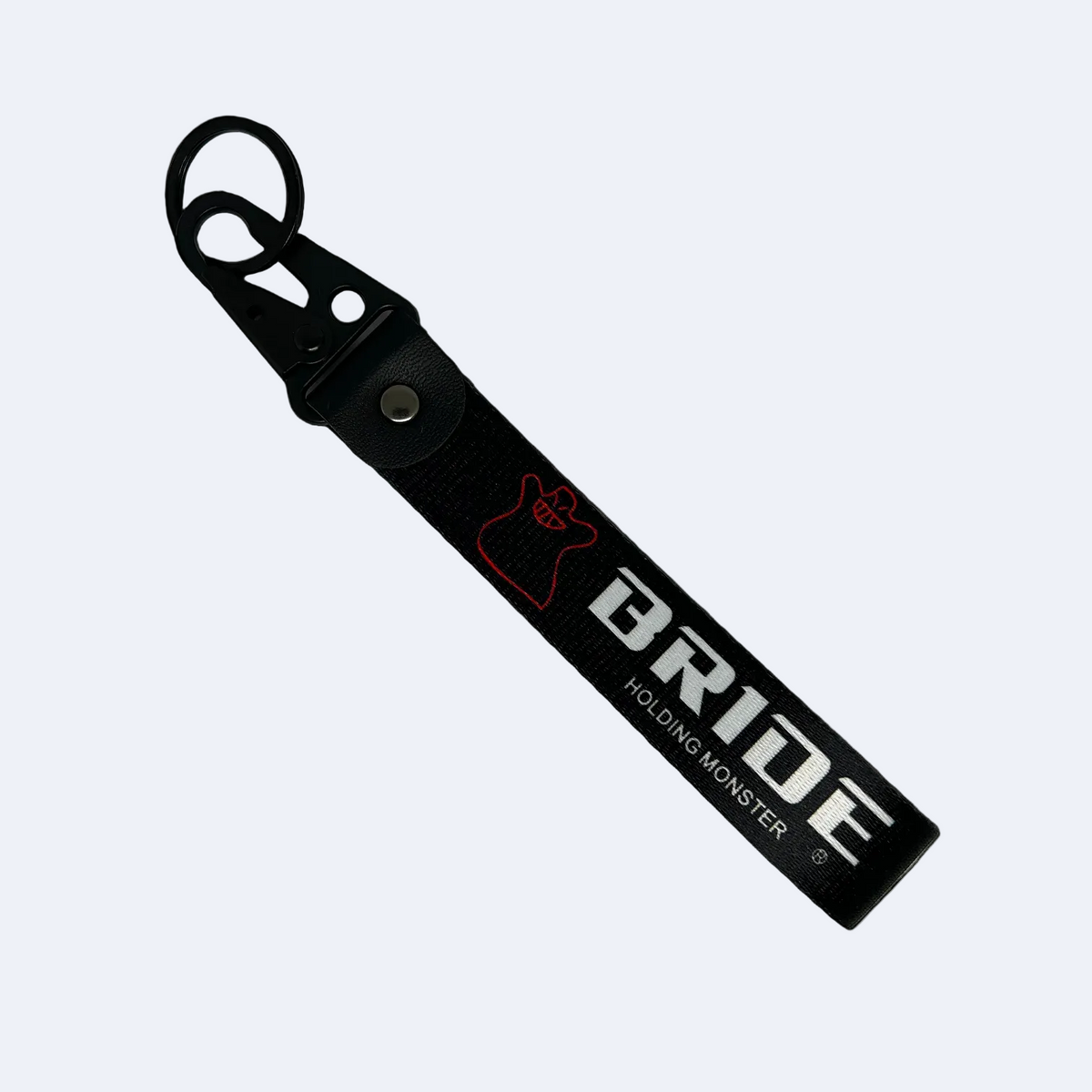 Black key tag with BRIDE HOLDING MONSTER branding in white print – Motorev embroidered car keychain