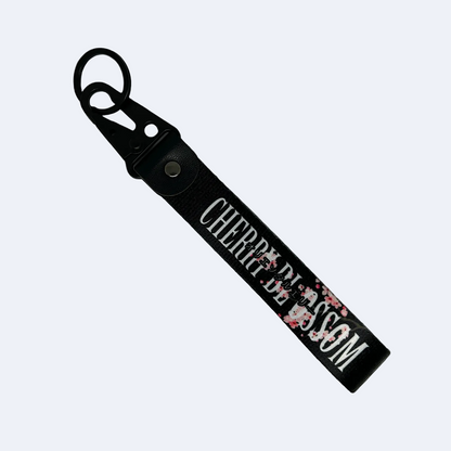 Black key tag with a floral cherry blossom design and cherry clossom in text – Motorev car accessory