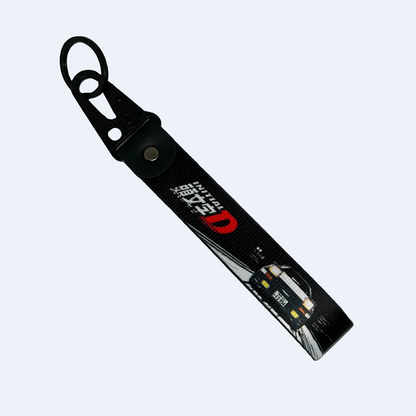 Black key tag with a Toyota AE86 and the Initial D manga logo – Motorev JDM car accessory