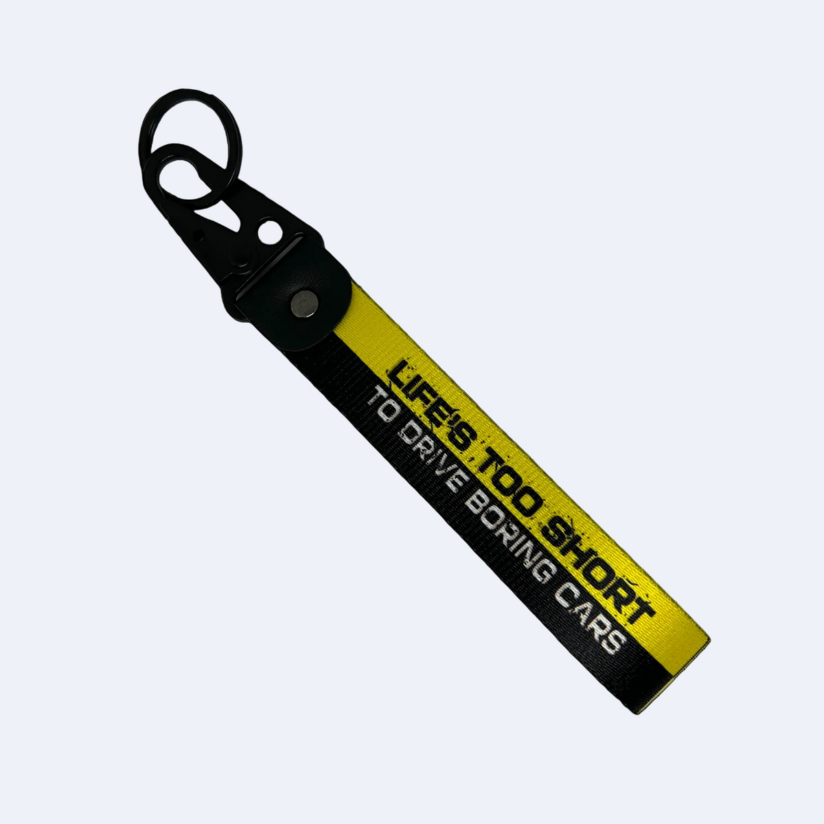 Black and yellow key tag with "Life's too short to drive boring cars" text – Motorev JDM car accessory