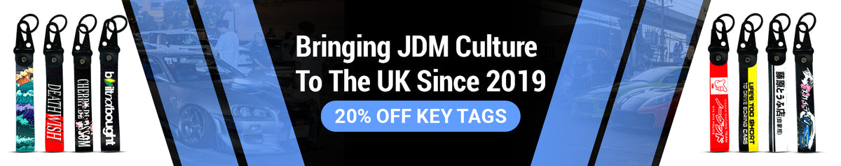 Motorev JDM car key tags homepage banner with split layout showcasing Death Wish, Cherry Blossom, Bitnatbought, Osaka Racing Team and Life's Too Short wrist strap keyrings against a JDM car meet background, UK automotive accessories since 2019