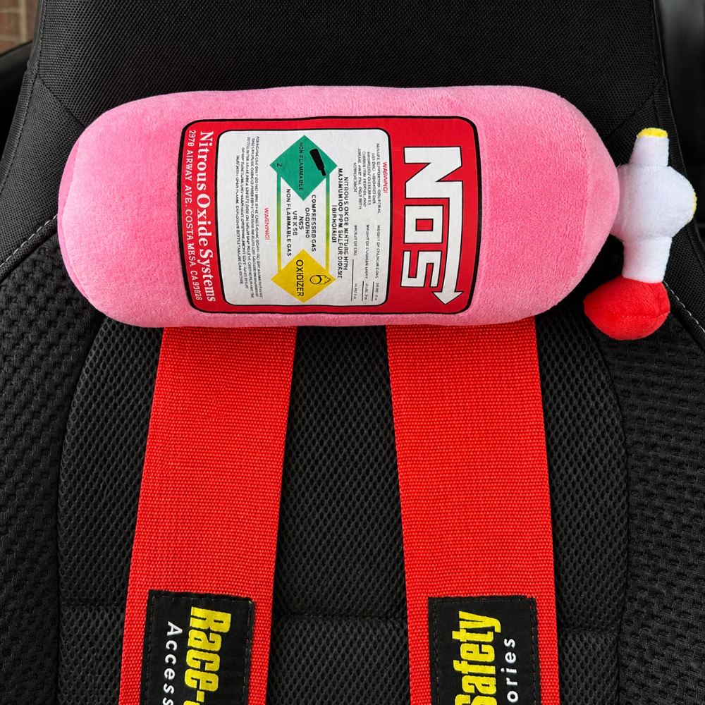 Pink NOS bottle cushion with strap installed in a Subaru WRX – Motorev car accessory