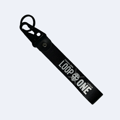 Black key tag featuring "Osaka JDM" and "Loop One" text – Motorev embroidered car keychain