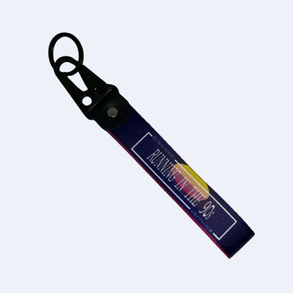 Purple key tag with a 90's sunset aesthetic and text that reads "Running In The 90's" – Motorev performance car keychain