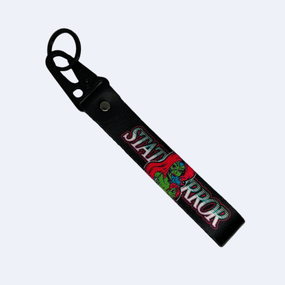 Motorev STATUS ERROR Zombie Girl car key tag, a zinc alloy and nylon keyring featuring a striking zombie girl graphic design, scratch resistant and built for car culture and alternative style enthusiasts UK