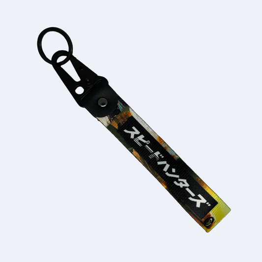 Key tag with a background image of a car scene and Japanese text reading "Speedhunters" – Motorev performance car keychain