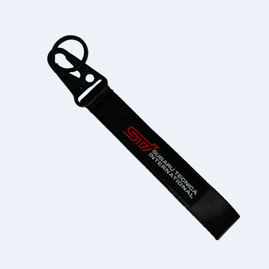 Motorev Subaru STI embroidered car key tag, a wrist strap keyring featuring the iconic STI logo stitched in detail, built for Subaru and JDM enthusiasts UK